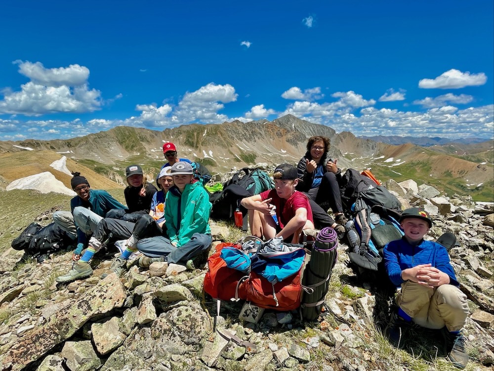 A group of young hikers on a summit.